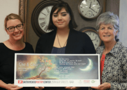 Maribella Smith with her winning poem, her teacher, and Jody Graf