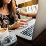 Woman working at a computer with coffee