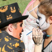 Student enjoying face-painting at a Harvest Festival