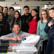 Photo of Andrew Vanden Akker and his University Prep Students with donations for Camp Fire Victims