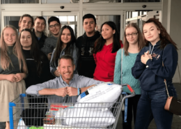 Photo of Andrew Vanden Akker and his University Prep Students with donations for Camp Fire Victims