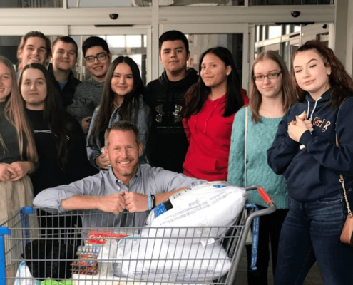 Photo of Andrew Vanden Akker and his University Prep Students with donations for Camp Fire Victims