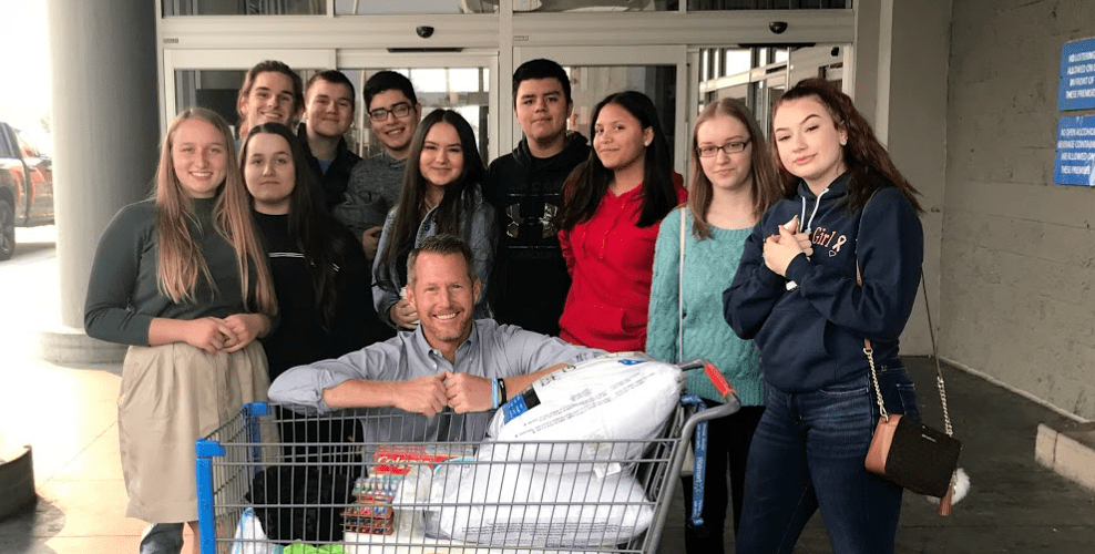 Photo of Andrew Vanden Akker and his University Prep Students with donations for Camp Fire Victims