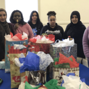 Photos of students with wrapped presents for charity
