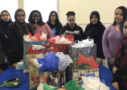 Photos of students with wrapped presents for charity