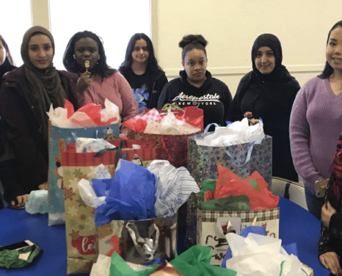 Photos of students with wrapped presents for charity