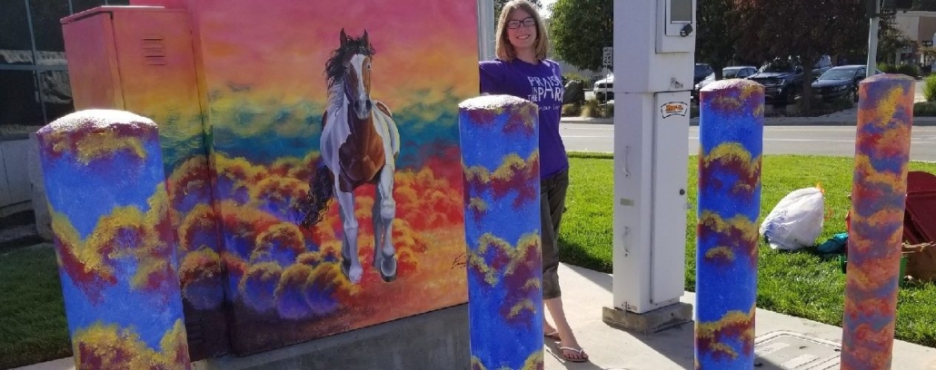 Photo of Emma S. with her painted utilities box in Brentwood