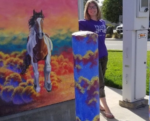 Photo of Emma S. with her painted utilities box in Brentwood