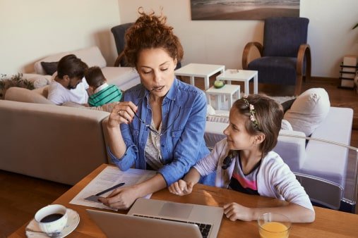 A parent and yound female student of Visions In Education  Home School Academy does homework on kitchen table