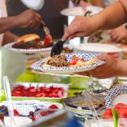 Guests filling plates at a summer cookout