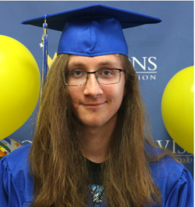 Male graduate smiling at the camera with cap and gown