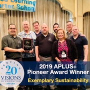 Visions staff accepts award at APLUS+ conference