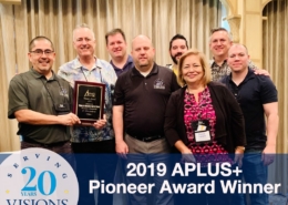 Visions staff accepts award at APLUS+ conference