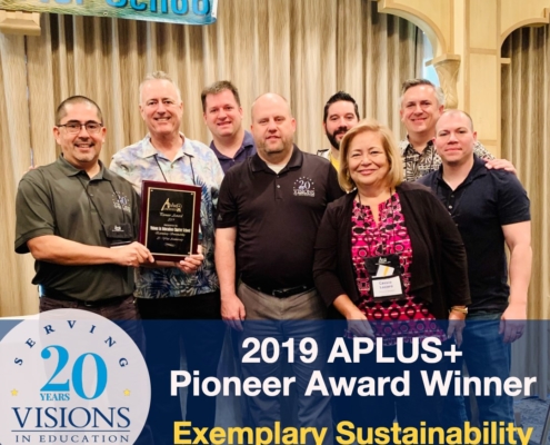 Visions staff accepts award at APLUS+ conference