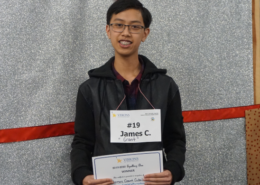 Male student smiles at the camera after winning the spelling bee