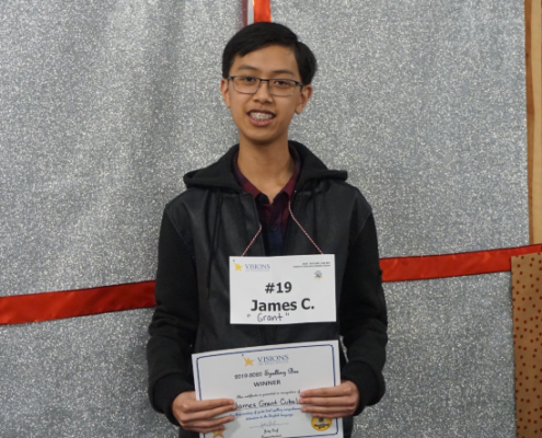 Male student smiles at the camera after winning the spelling bee