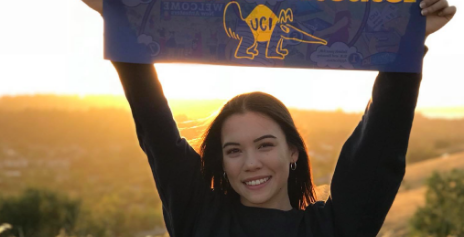 Smiling female online high school student holding college prep banner