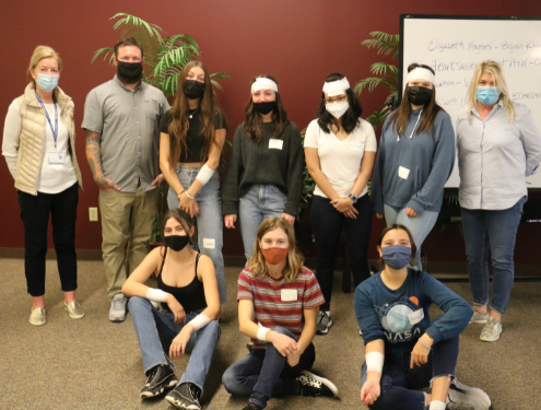 Students participated in activities including mock-bandaging and CPR chest compressions on dummies under the supervision of trained CPR professionals