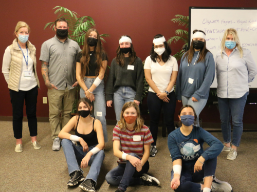 Students participated in activities including mock-bandaging and CPR chest compressions on dummies under the supervision of trained CPR professionals