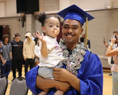 High school graduate celebrates at summer graduation after catching up on credits