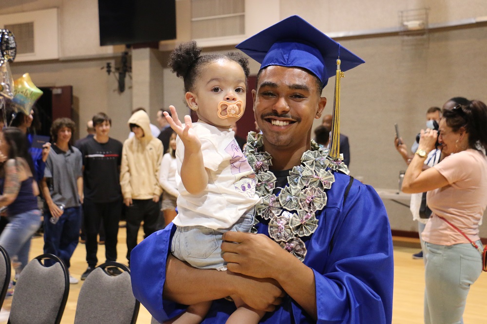 High school graduate celebrates at summer graduation after catching up on credits