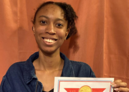 Smiling home school student holds up her State Seal of Biliteracy certificate