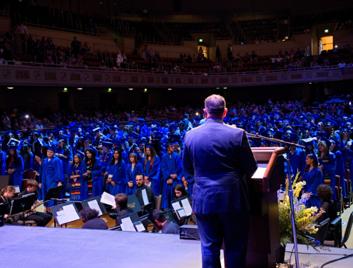 Superintendent looks out into the crowd of graduates from the podium at graduation