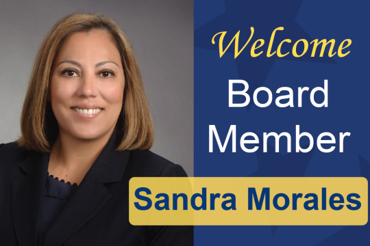 New board member Sandra smiles at the camera, graphic includes text "welcome board member Sandra Morales"