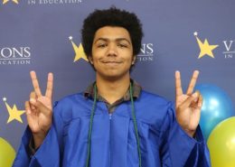 Lenny, eSports champ, Visions graduate and STS staff member gives the peace sign at high school graduation