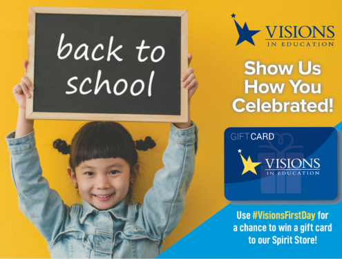 Young girl smiles and holds up a chalkboard sign that says "Back to School" on it