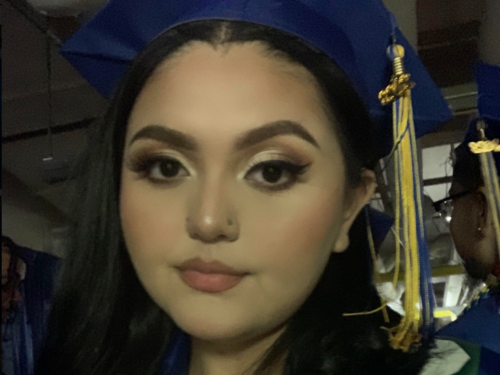 Selfie of a teenage girl in a blue graduation cap with blue and gold tassel.