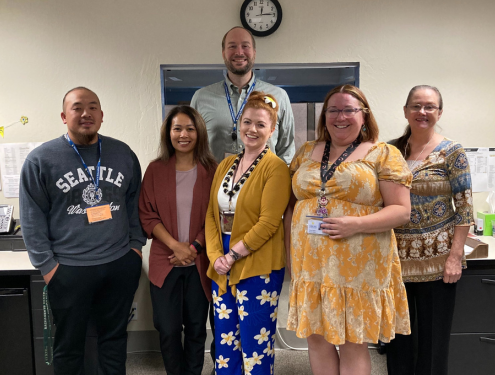 6 Fiscal Services team members gather together for a staff photo in their office area.