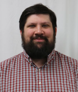 mike miller Michael Miller (staff member) in a red plaid shirt smiles for a staff photo.