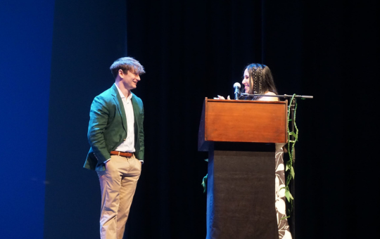 Alumni Hall of Fame Inductee William Lynch and his teacher on stage at the August staff back to school event.