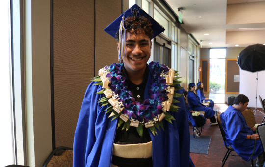 Visions graduate in his cap and gown