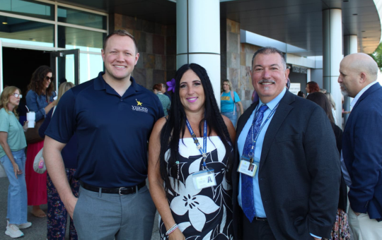 Group photo of Alumni Hall of Fame Inductee Tanner Zumwalt, his former Visions teacher, and Superintendent Steve Olmos.