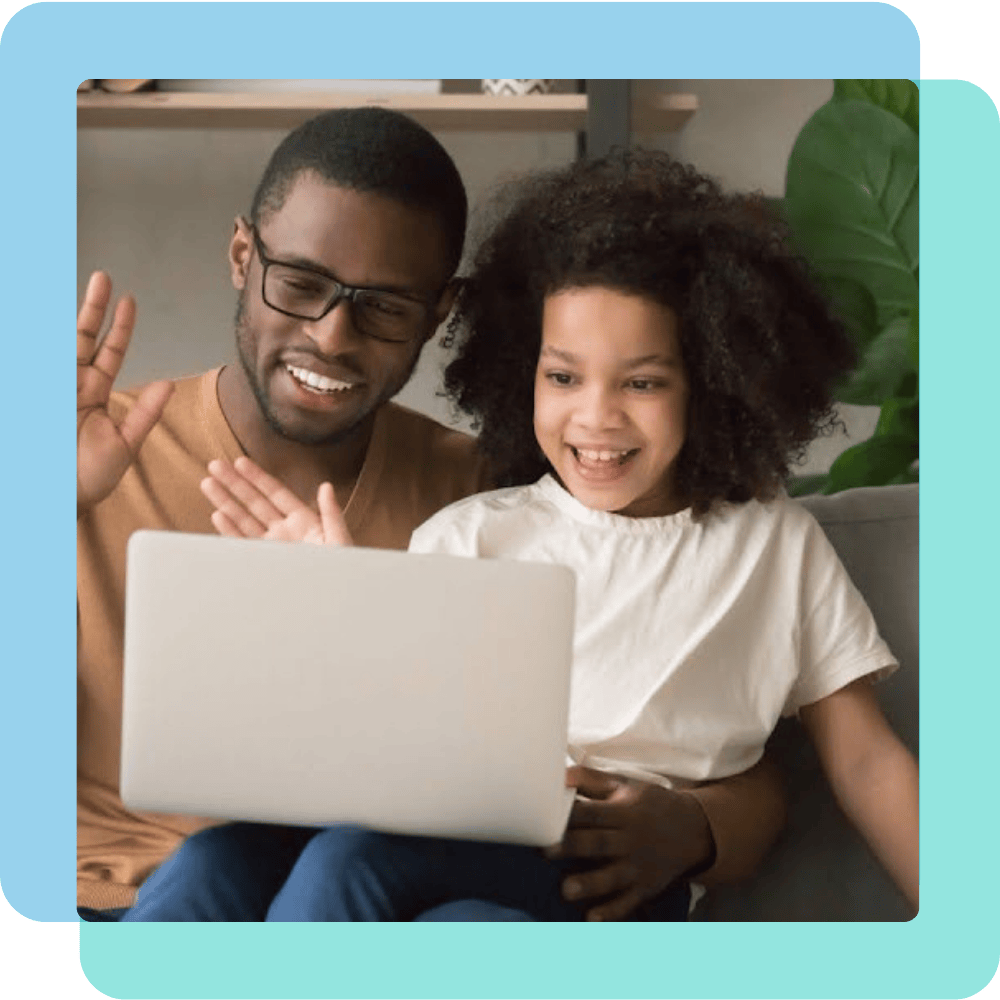 Father and daughter smiling and waving at a screen