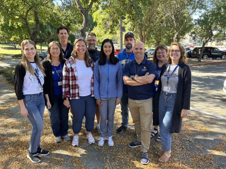 Group photo of teacher's with a Visions student.