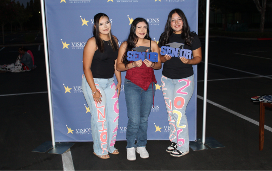 Visions Seniors gather to take a picture in their customized apparel