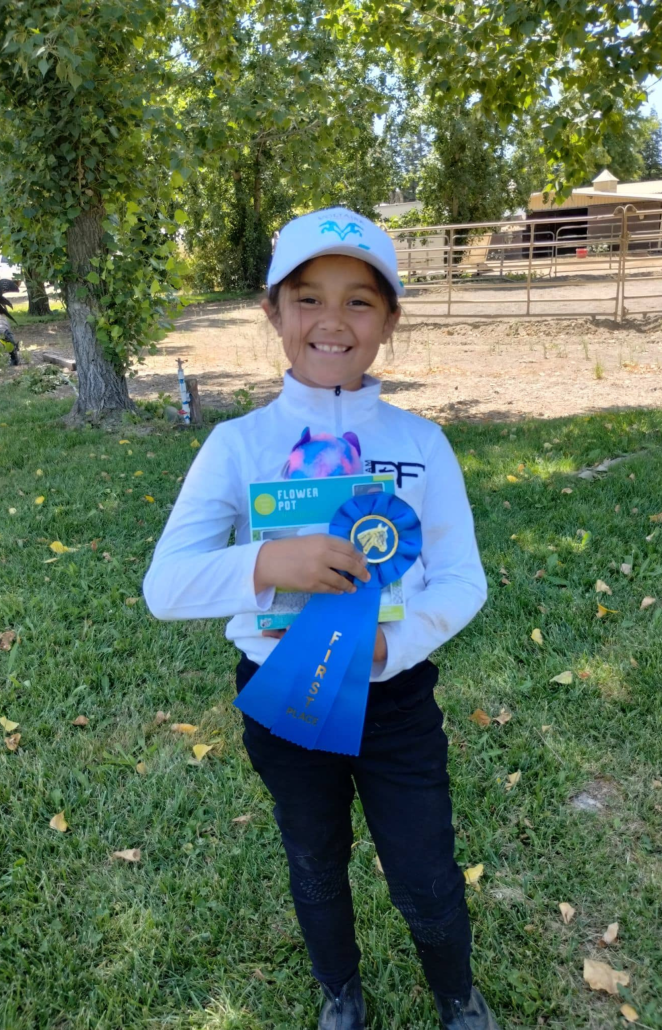 kai'lea poses with her flower pot and winner ribbon