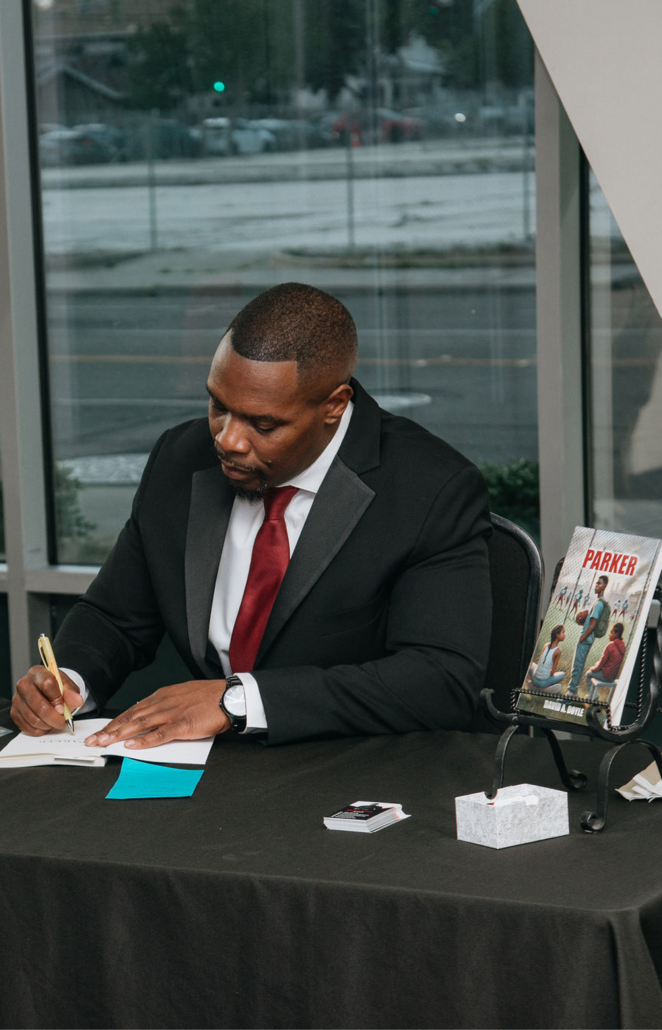 David signing autographs at his book launch party.