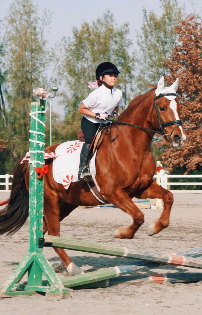 kai'lea participating in a jump competition with her horse, Penny.