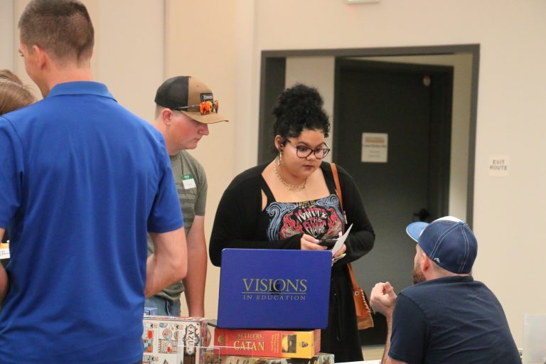 Visions students are speaking with a Visions Club Advisor at Club Rush 2025