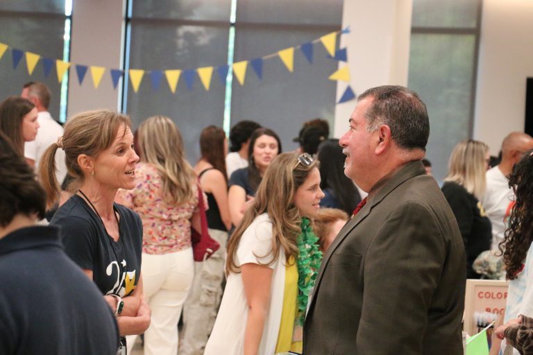 Superintendent Steve Olmos speaks to a staff member at Visions Club Rush 2025