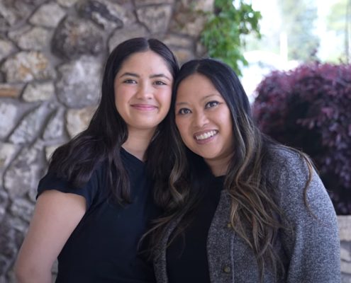 Mother and daughter smile together.