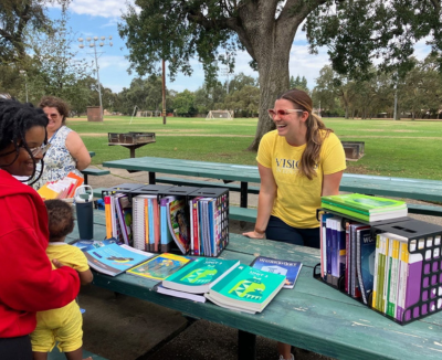 Kaylee tabling at a Visions in-person event