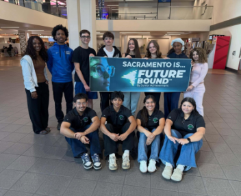 Visions In Education and El Camino Fundamental High School students post for a photo with a Junior Achievement Future Bound banner in the airport.