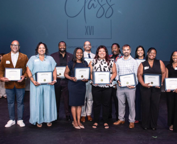 Matt Patterson stands with his leadership cohort and proudly poses for a group picture with his program graduate certificate.