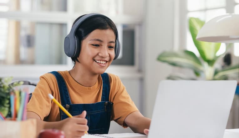 A parent and young female student of Visions In Education  Home School Academy does homework on kitchen table